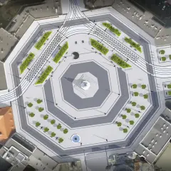 Nowoczesny plac wolności w Łodzi z zielonymi wyspami, szachownicą i torami tramwajowymi.