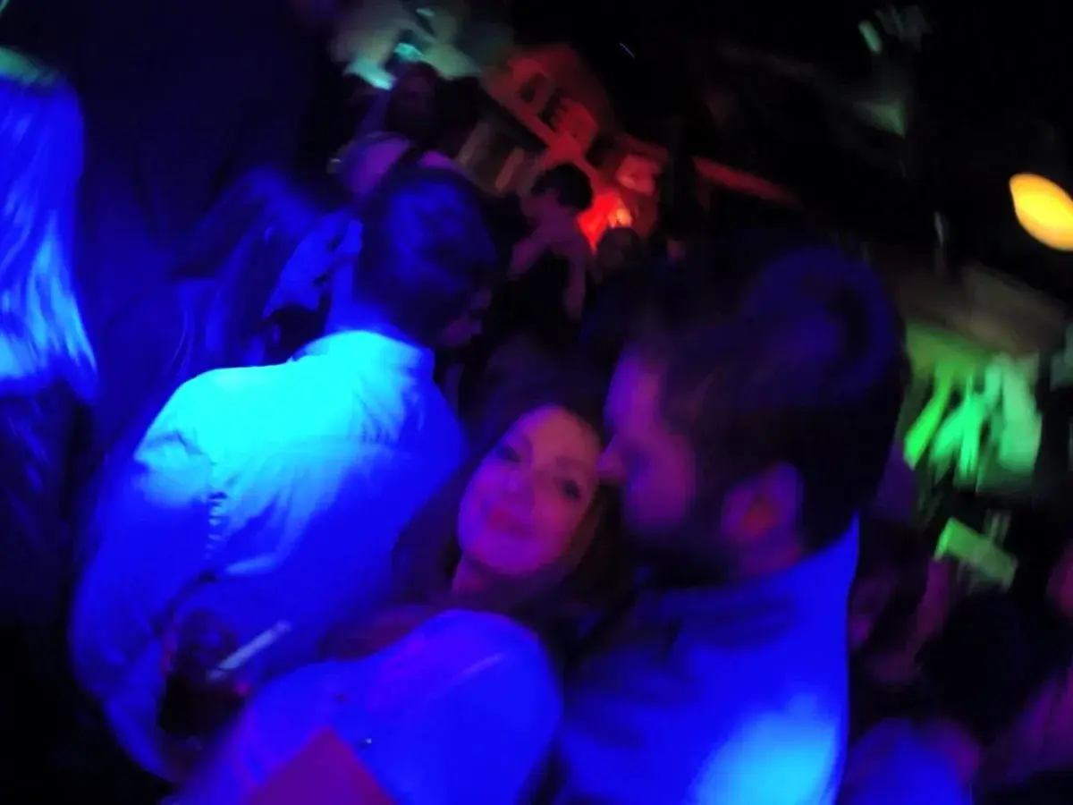Nocny klub w Sopocie, ludzie tańczą w świetle niebieskich i zielonych lamp.